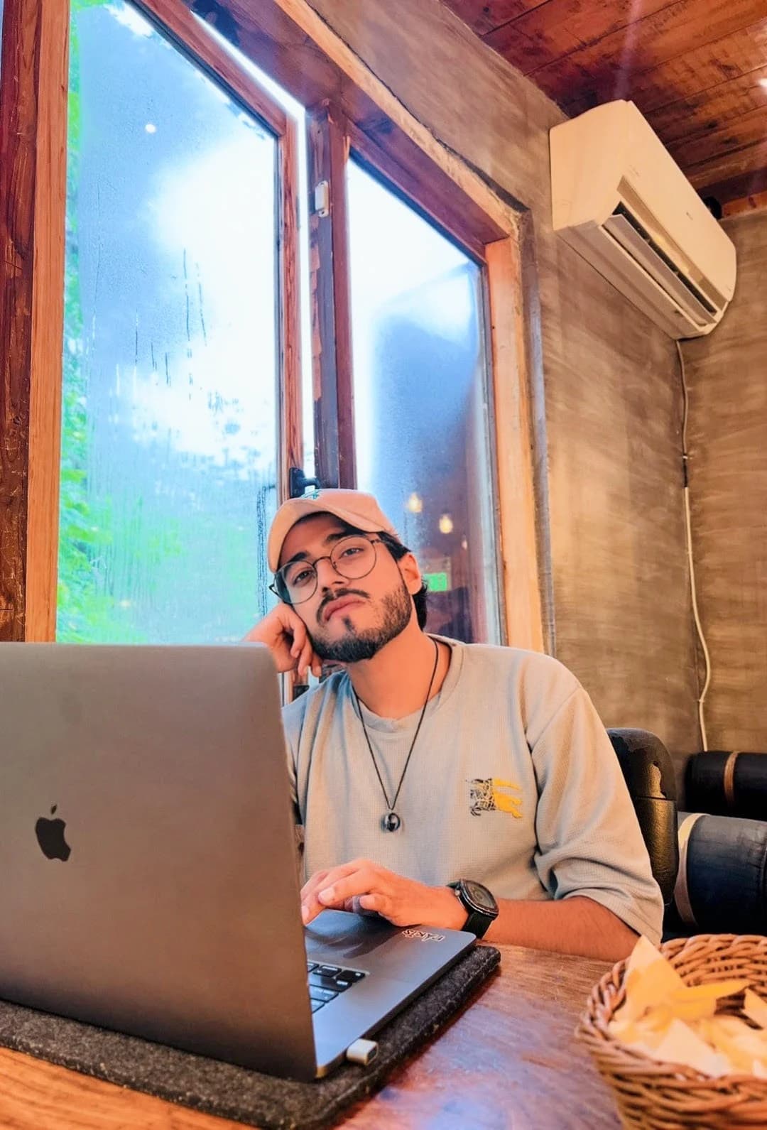 Haseeb seated at a table and working on a laptop.